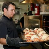 Lemoore Vineyard Restaurant manager Joe Jones shows off a pan full of lobster tails cooked to perfection and eagerly awaited by customers.